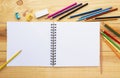 Many colored pencils with the white notebook on wood table for p Royalty Free Stock Photo