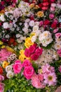 Many colorful artificial fake flowers background blooming beautiful