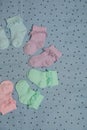 Many colorful baby socks on light blue fabric, flat lay Royalty Free Stock Photo