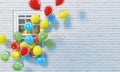 Many colorful balloons fly out from an open window on the background of a white brick wall. Copy space. 3D render.