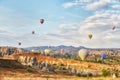 Many colorful balloons take off into the sky at dawn. All the sky in big beautiful balloons. Fabulous landscapes of the mountains Royalty Free Stock Photo