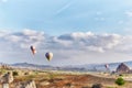 Many colorful balloons take off into the sky at dawn. All the sky in big beautiful balloons. Fabulous landscapes of the mountains Royalty Free Stock Photo