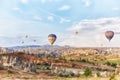 Many colorful balloons take off into the sky at dawn. All the sky in big beautiful balloons. Fabulous landscapes of the mountains
