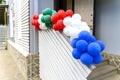 Many colorful balloons are tied to the stairs and hung up for a holiday Royalty Free Stock Photo