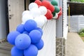 Many colorful balloons are tied to the stairs and hung up for a holiday Royalty Free Stock Photo