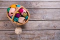 Many colorful balls of yarn in a wicker basket. Royalty Free Stock Photo