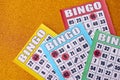 Many colorful bingo boards or playing cards for winning chips. Classic US or canadian five to five bingo cards on bright