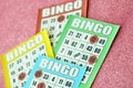 Many colorful bingo boards or playing cards for winning chips. Classic US or canadian five to five bingo cards on bright