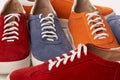 Many colorful casual unisex suede shoes background
