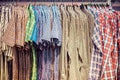 Many colorful checkered formal men shirts hanging on a rack, Row of men`s suits hanging in closet, concept of buy and sell. Royalty Free Stock Photo