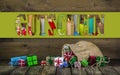 Many colorful christmas presents on wooden old background. Royalty Free Stock Photo