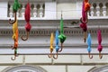 Many colorful closed umbrellas hanged outside on the street