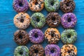 Many colorful fun donuts with and sugar eyes for Halloween, full frame, flat lay Royalty Free Stock Photo