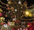 Many colorful gift boxes and other christmas decorations under a beautiful decorated christmas tree with bokeh lights Royalty Free Stock Photo