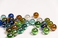 Many colorful glass round beads, balls on a white background close-up Royalty Free Stock Photo