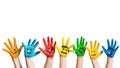 Many colorful hands with smileys