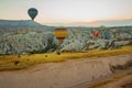 Many colorful hot air balloons flight above mountains - panorama of Cappadocia at sunrise. Wide landscape of Goreme valley Royalty Free Stock Photo