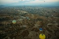 Many colorful hot air balloons flight above mountains - panorama of Cappadocia at sunrise. Wide landscape of Goreme valley Royalty Free Stock Photo