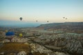 Many colorful hot air balloons flight above mountains - panorama of Cappadocia at sunrise. Wide landscape of Goreme valley Royalty Free Stock Photo