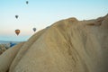 Many colorful hot air balloons flight above mountains - panorama of Cappadocia at sunrise. Wide landscape of Goreme valley Royalty Free Stock Photo