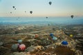 Many colorful hot air balloons flight above mountains - panorama of Cappadocia at sunrise. Wide landscape of Goreme valley Royalty Free Stock Photo