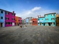 Colorful houses on a small traditional square at Burano island, Venice, Italy Royalty Free Stock Photo