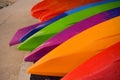 Many colorful kayaks lie on the ocean shore Royalty Free Stock Photo