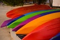 Many colorful kayaks lie on the ocean shore Royalty Free Stock Photo