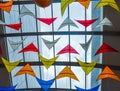Many colorful kites against the glass roof