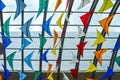 Many colorful kites against the glass roof