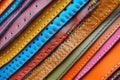 Many colorful leather sheets stack with stitches for background use