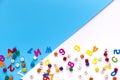 Many colorful letters and nubmers on white and blue background