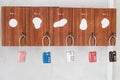 Many colorful metal locks on room number wooden box