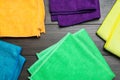 Many colorful microfiber cloths on wooden table, flat lay Royalty Free Stock Photo
