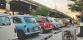 Many colorful mini Austin classic or cooper parked on street for group meeting