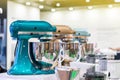 Many colorful and modern stand food mixer machine for industrial or home on table on blur background with copy space
