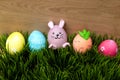 Many colorful painted Easter eggs in grass. Easter bunny and carrot egg Royalty Free Stock Photo