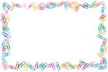 Colorful frame of cluttered paper clips on white background