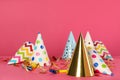 Many colorful party hats and festive items on pink background Royalty Free Stock Photo