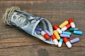Many Colorful Pills And Capsules Dropped From Money Roll Royalty Free Stock Photo