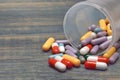 Many Colorful Pills And Capsules Dropped On Wooden Background Royalty Free Stock Photo