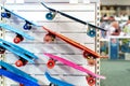 Many colorful plastic small skateboards toys hanged on store shop window display. Child sport and fun accessories. Children gift