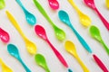 Many colorful plastic spoons on white background, top view Royalty Free Stock Photo
