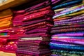 colorful red, purple, pink, yellow, blue, green and orange textile fabrics for sale in a shop Royalty Free Stock Photo