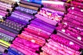 colorful red, purple, pink, yellow, blue, green and orange textile fabrics for sale in a shop Royalty Free Stock Photo