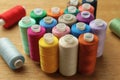 Many colorful sewing threads on wooden table Royalty Free Stock Photo