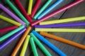 Many colorful straws for drinks lie on a wooden table. A circle of tubes. Plastic straws in the form of rays on the Royalty Free Stock Photo