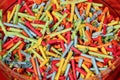 Many colorful tombola tickets are lying in a bowl