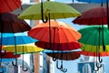 many colorful umbrellas fly and hover on the city street Royalty Free Stock Photo