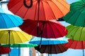 many colorful umbrellas fly and hover on the city street Royalty Free Stock Photo